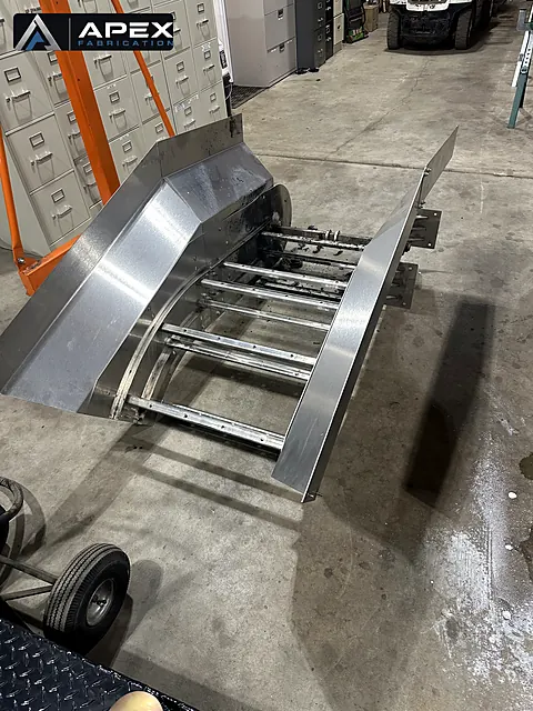 Stainless steel conveyor chute section with crossmembers during fabrication