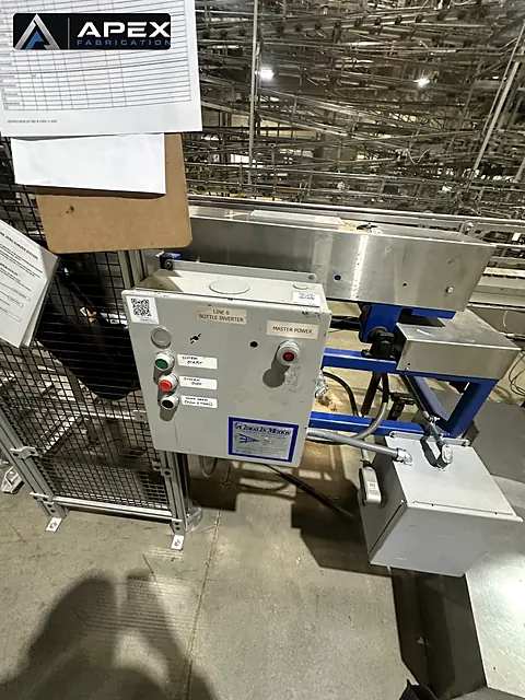 Control panel for a bottle inverter mounted on production line equipment inside a bottling facility