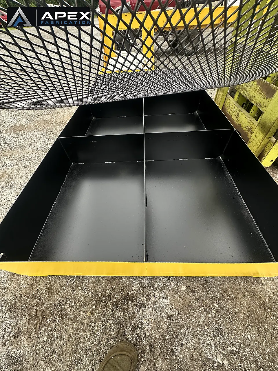 Black-coated interior compartments of a spill containment platform with grating removed