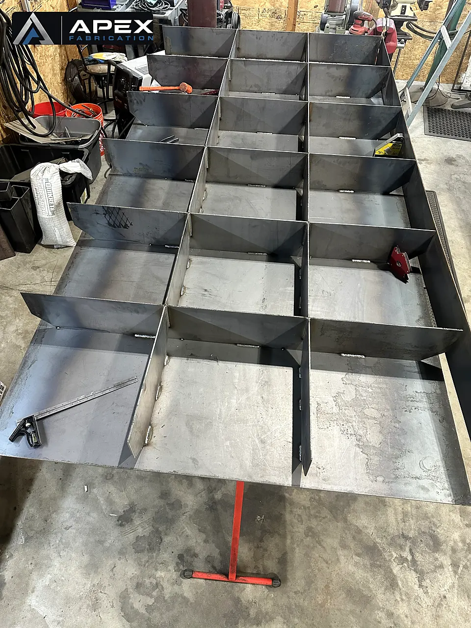 Overhead view of a compartmentalized steel tray fabrication before final welding
