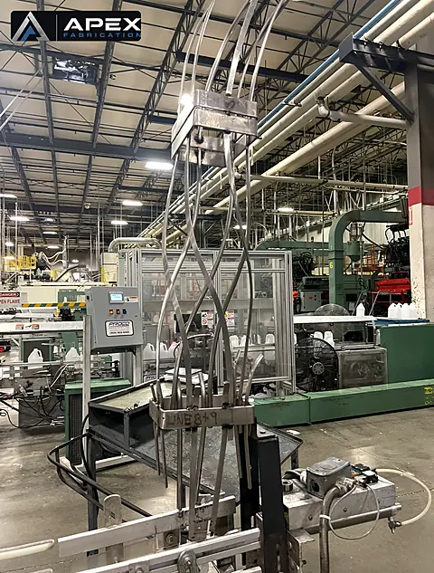 Stainless steel filling head with product tubes on a bottling line in a production plant
