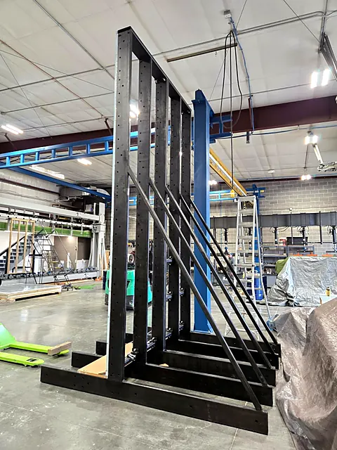 Heavy black steel A-frame rack with diagonal bracing fabricated in the Apex shop